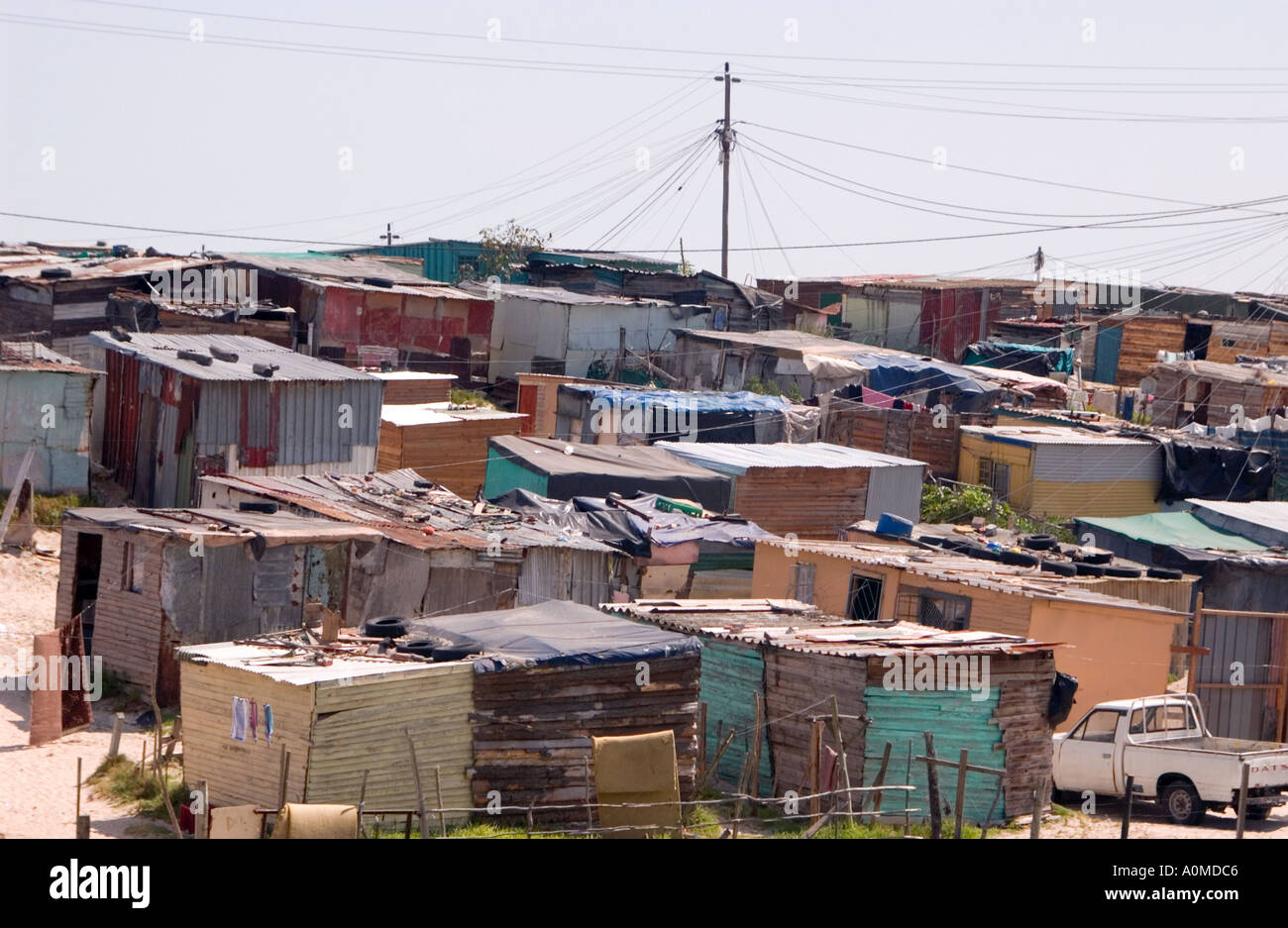 A view of shanties with power lines overhead in a township Cape Town South Africa Stock Photo