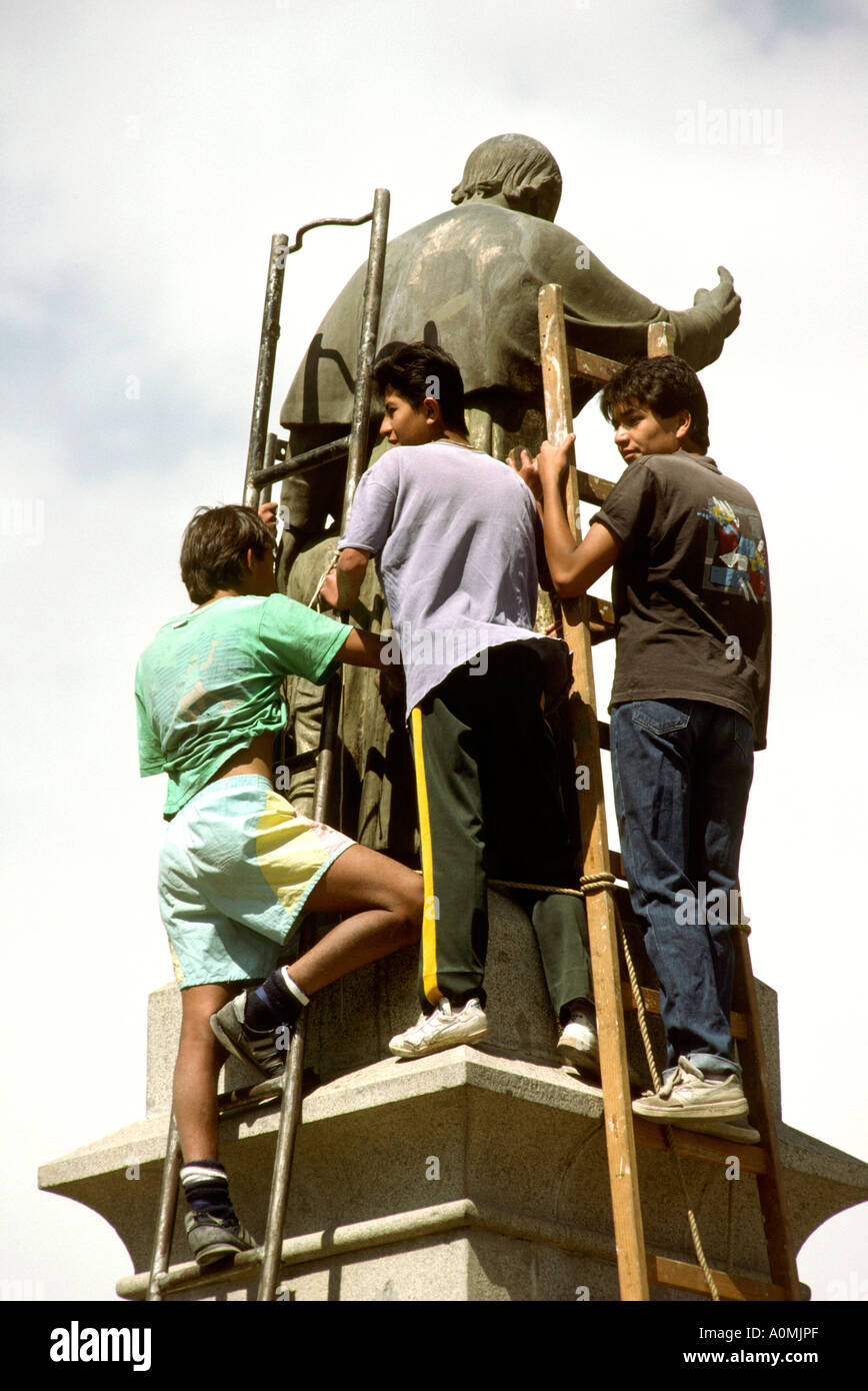 Peru Arequipa Boys cleaning statue Stock Photo