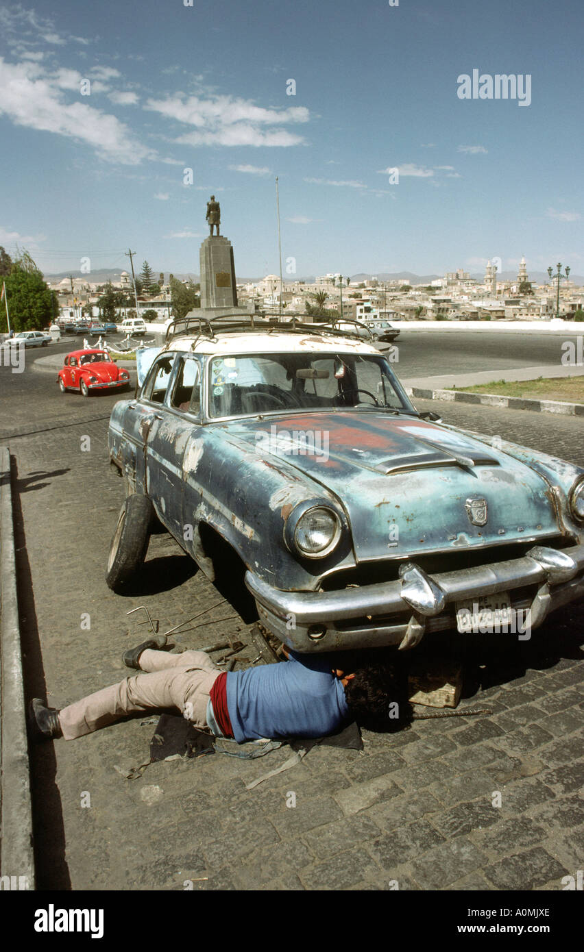 Peru Arequipa man repairing old American car Stock Photo: 5730861 - Alamy