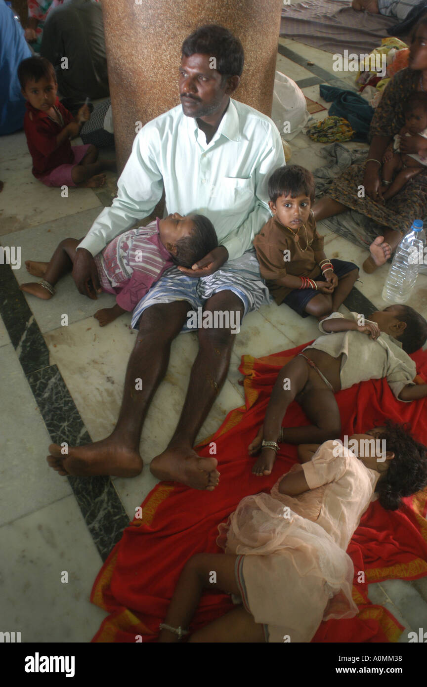 man sitting children sleeping after Tsunami earthquake Nagapattinum Velankanni Tamil Nadu india Stock Photo