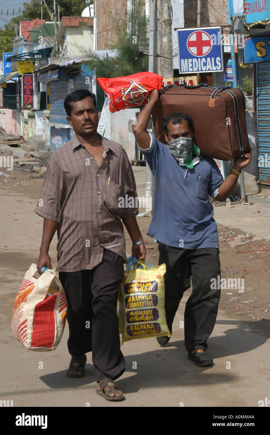 men leaving town after Tsunami earthquake Nagapattinum Velankanni Tamil Nadu India Stock Photo