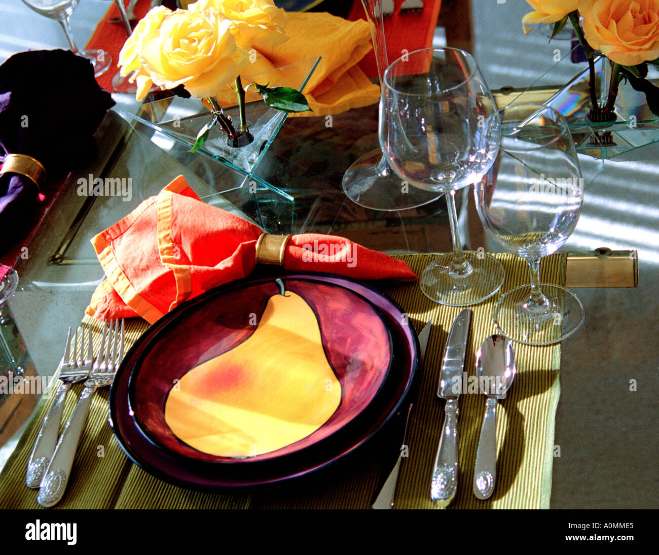 Colorful formal table setting with wine glasses and custom painted