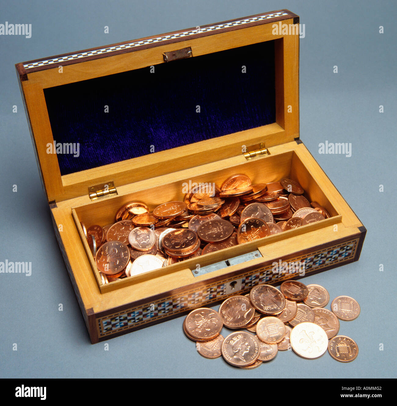 money box full of shiny new coins Stock Photo Alamy
