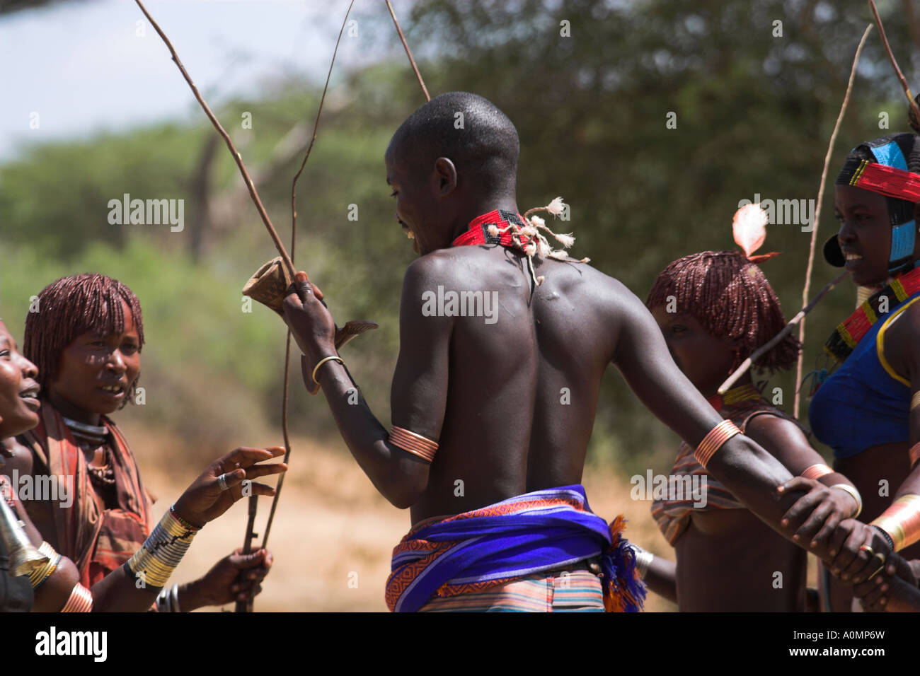 ETHIOPIA Lower Omo valley Turmi Hamer Jumping of the Bulls initiation ceremony Man whipping women on back in ritual flogging Stock Photo