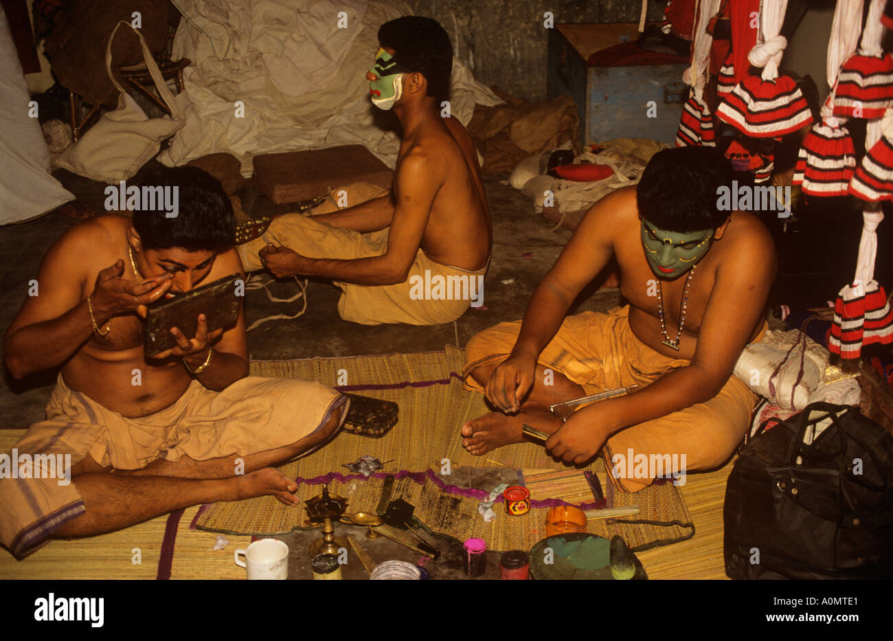 Kathakali dancers applying make up Kerala India Stock Photo