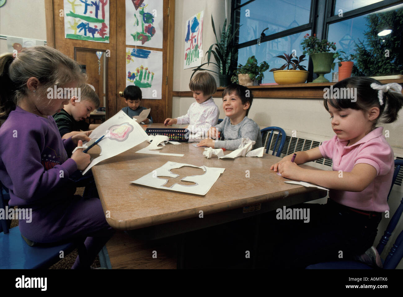 students kids child children concentrating skill group cutting shapes knowledge wisdom fun lesson Stock Photo