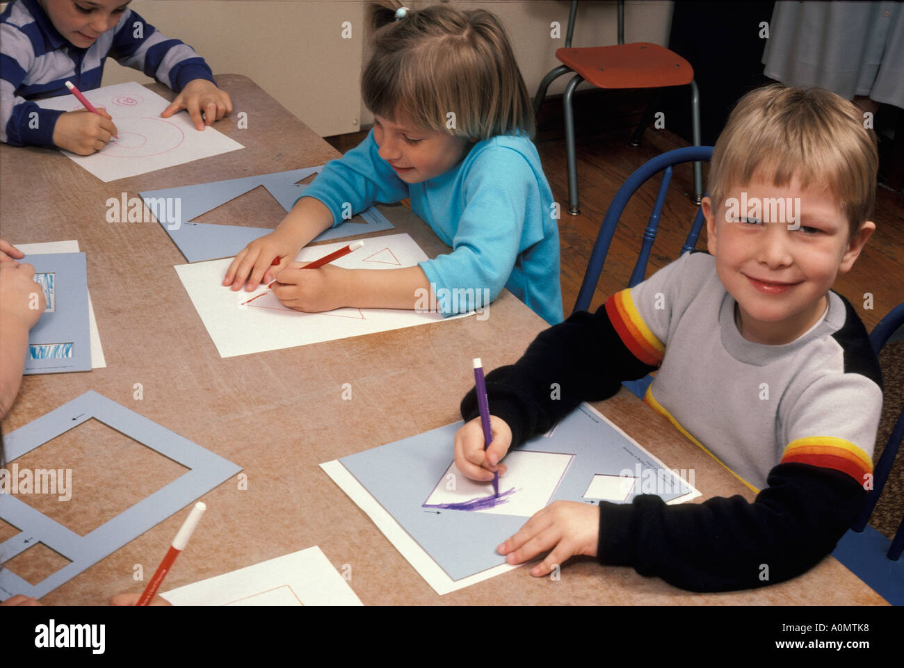 students kids child children concentrating skill group cutting shapes knowledge wisdom fun lesson Stock Photo