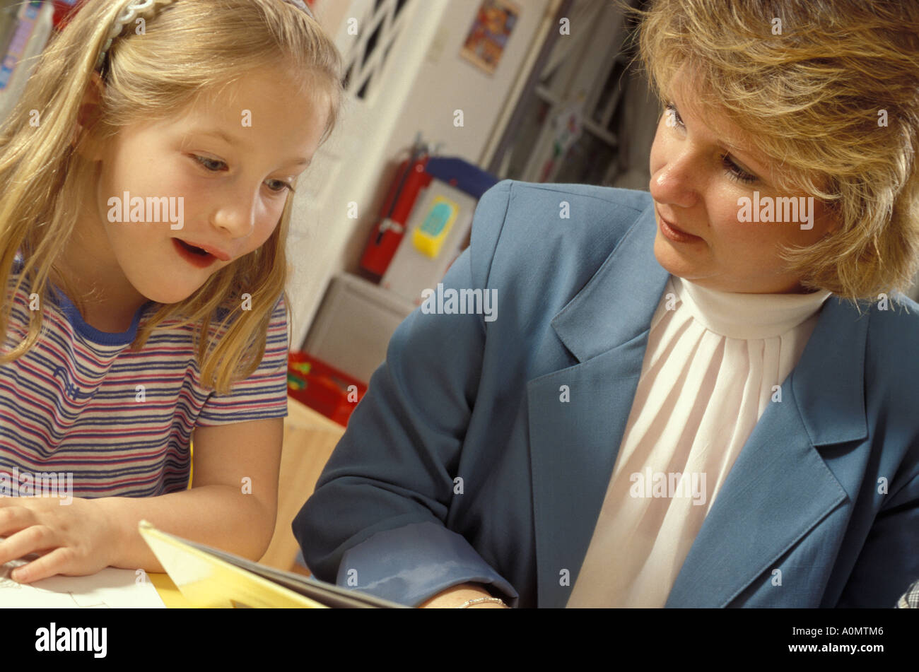 teacher administrator administrative young female girl student interact interaction Stock Photo