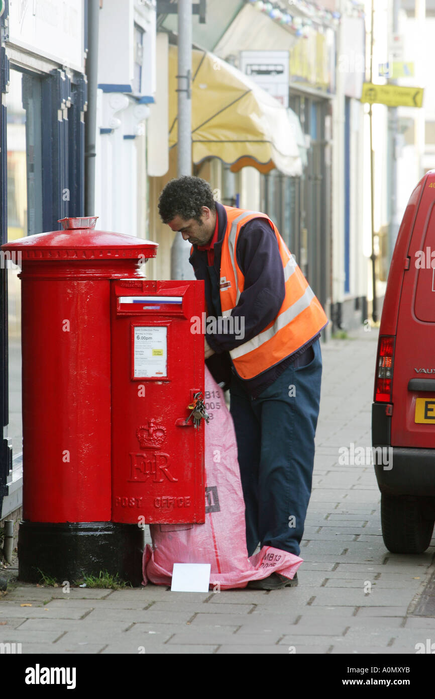 Postman emptying a postbox Stock Photo