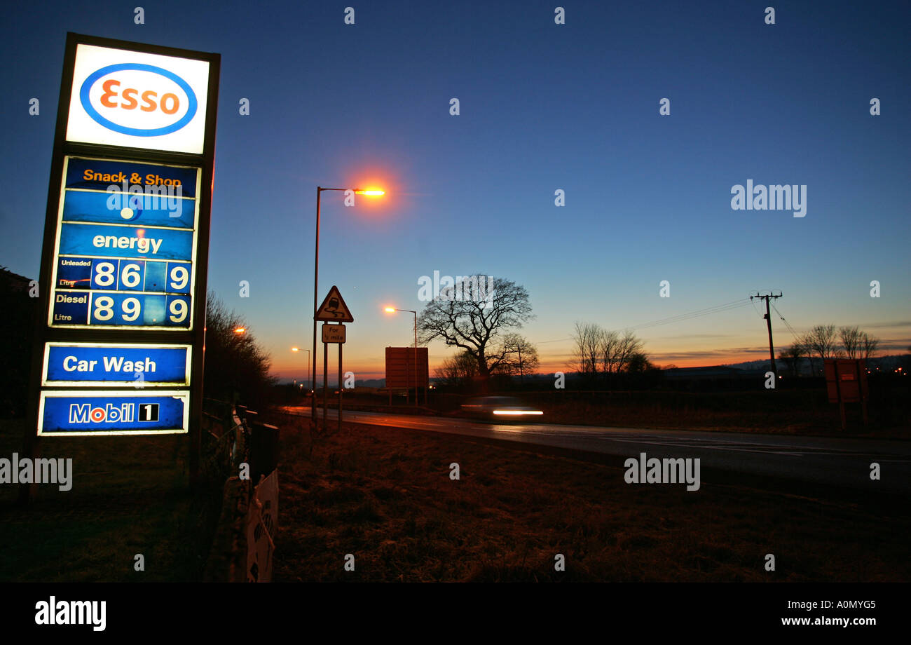 Esso filling station sign showing petrol and diesel prices at dusk ...