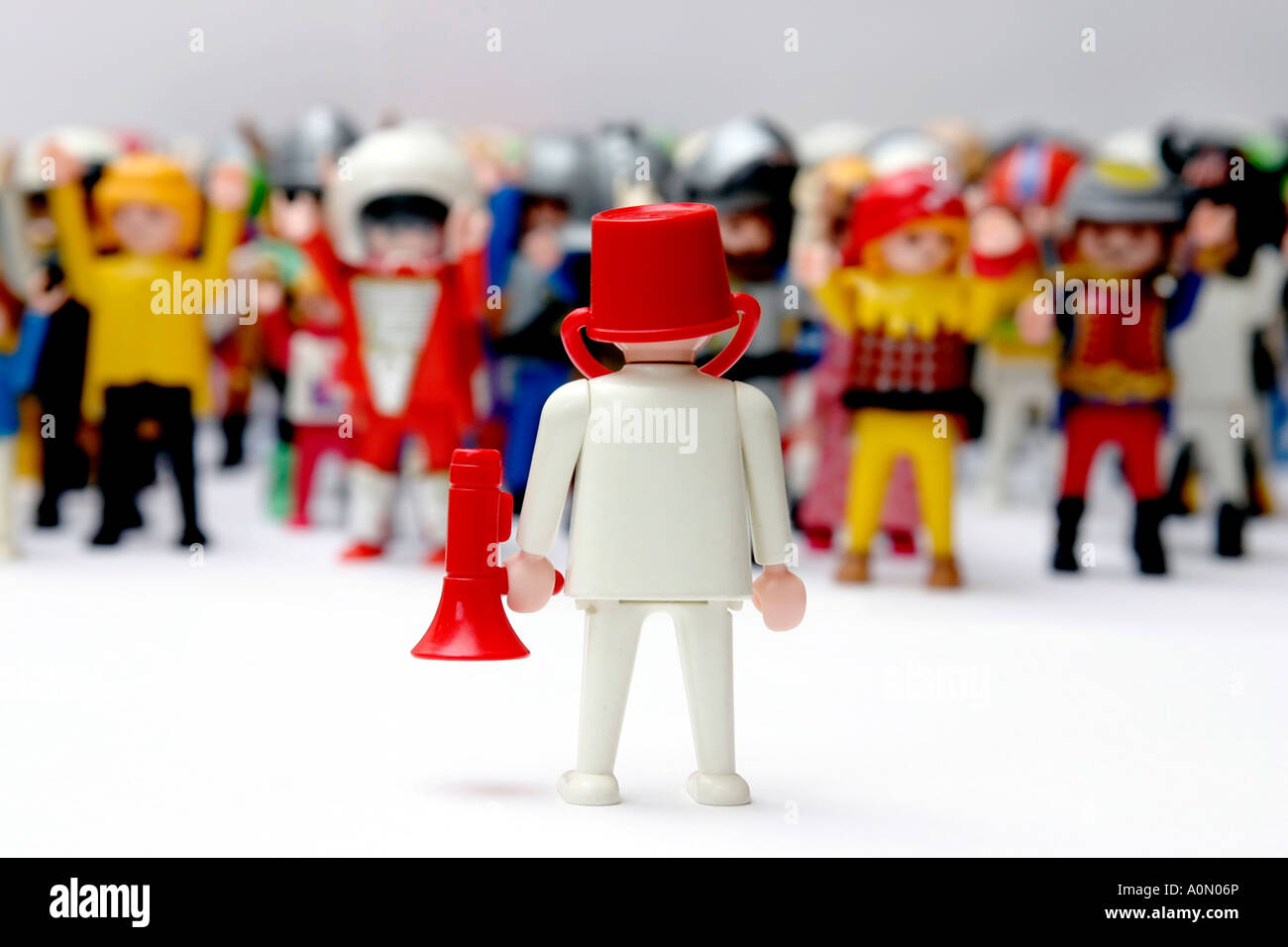 playmobil man wearing bucket on head and loudhailer addressing crowd of  figures Stock Photo - Alamy