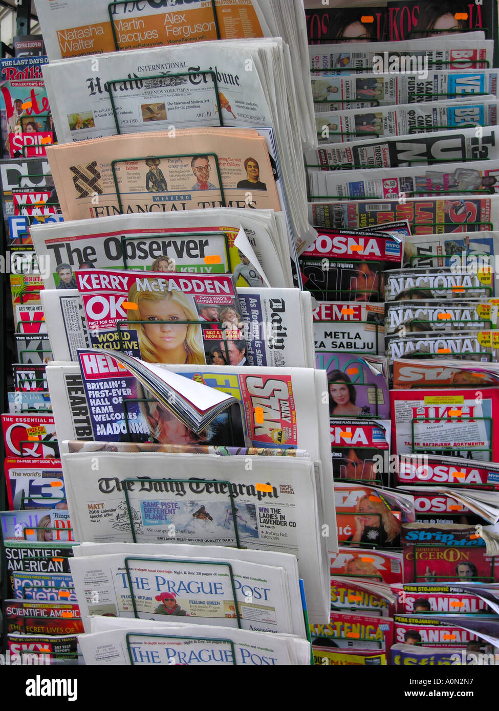 A broad range of international newspapers displayed on a rack outside a newspaper stall. Stock Photo