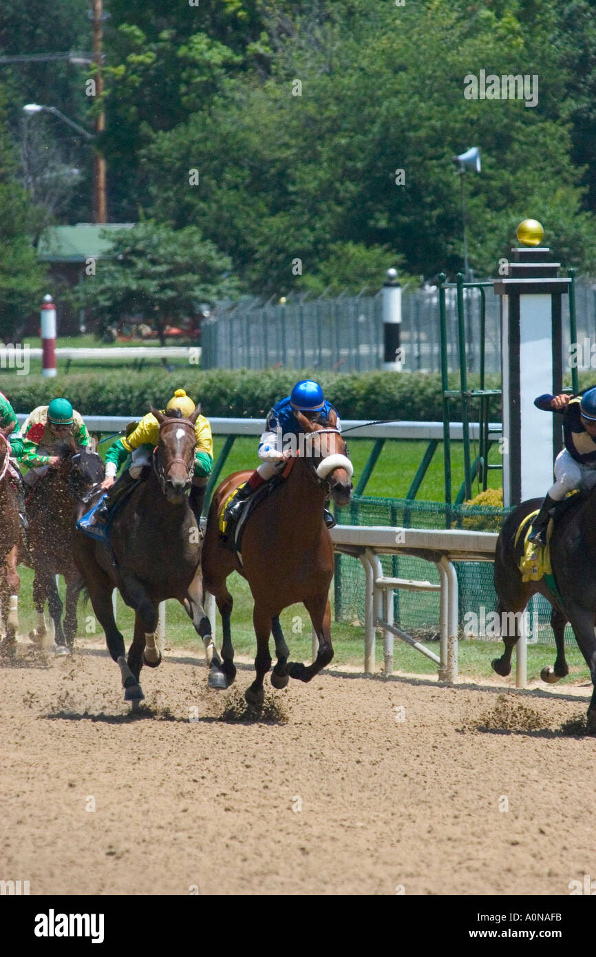 Race horses approaching finish line at Churchill Downs during race Stock Photo