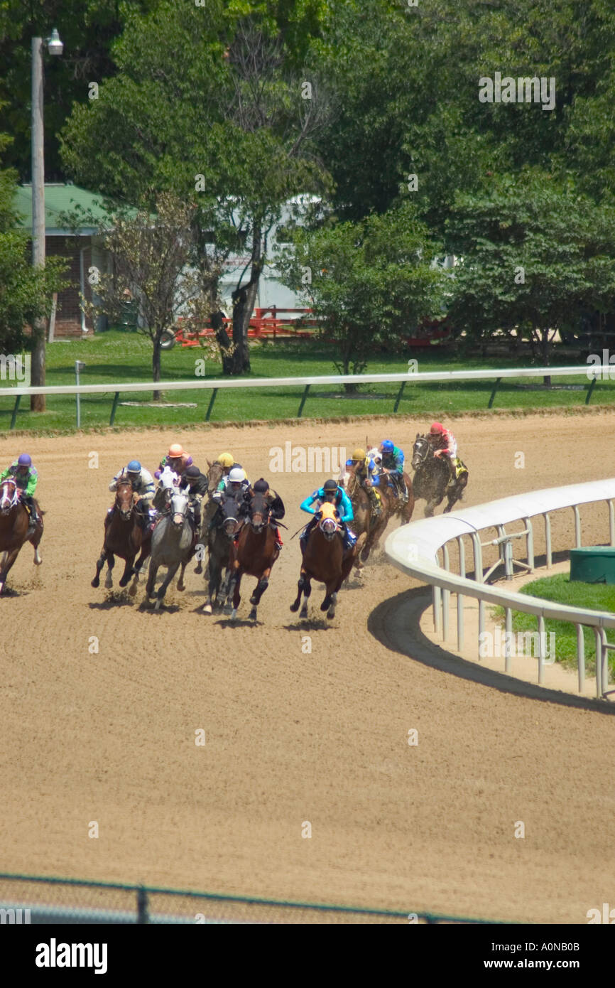 Race horses rounding third turn during race at churchill Downs Stock Photo