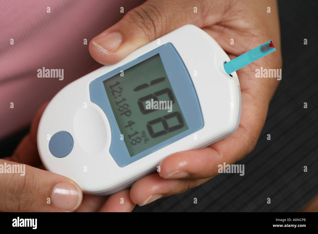 Diabetes testing device used by patients. Patient places drop of blood