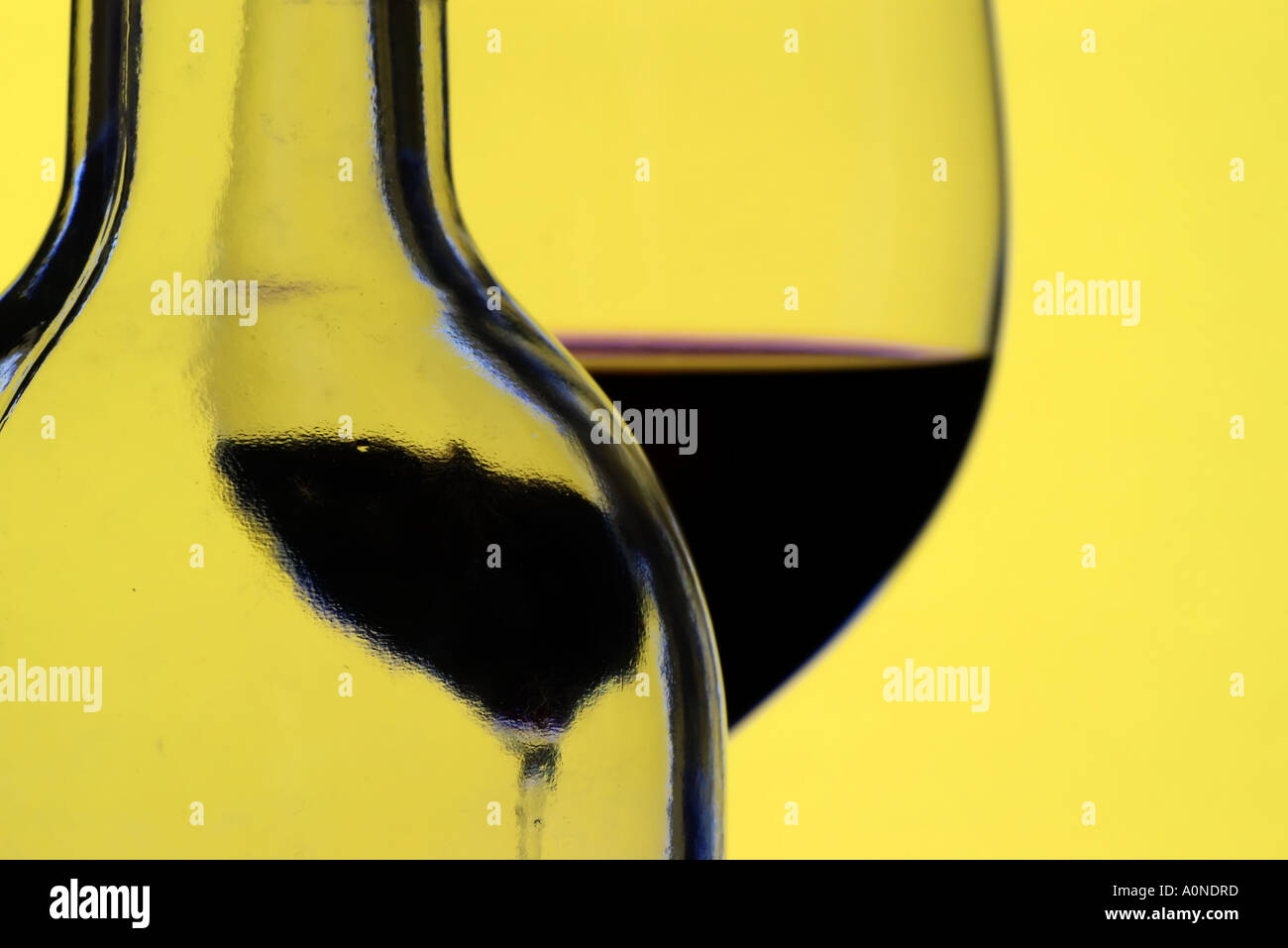 Red wine bottle and glass. Note Focus on the streaks of the bottle