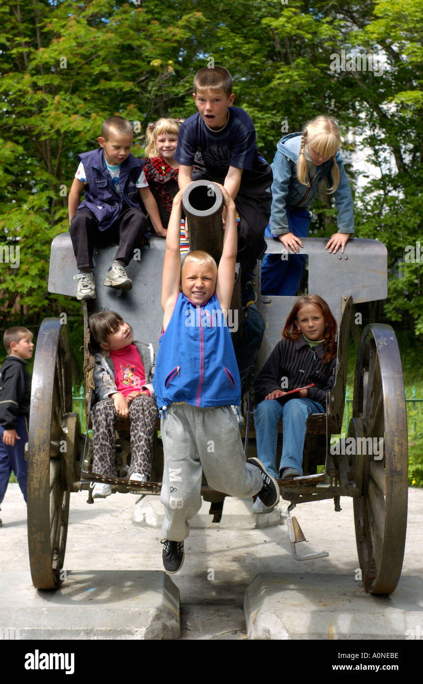 School children play on an old artillery piece at the Regional Museum in Yuzhno Sakhalinsk on Sakhalin Island in Russia 2004 Stock Photo