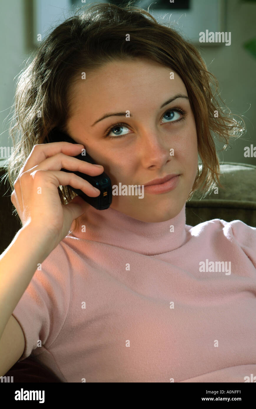 Woman rolling her eyes on the phone hires stock photography and images