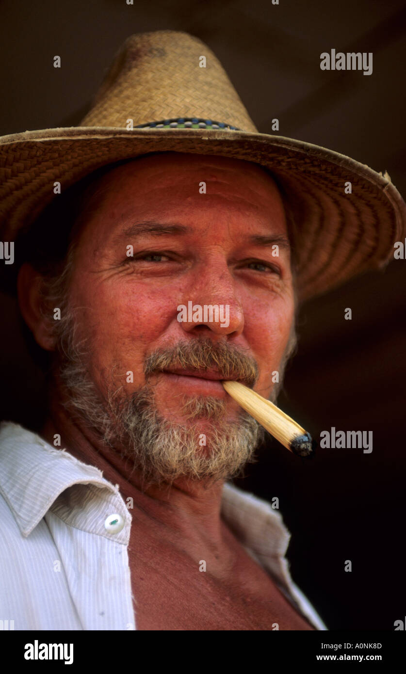 Amazon, Brazil. Old settler of European appearance wearing a straw hat and smoking a maize skin cigarette; Minas Gerais State. Stock Photo