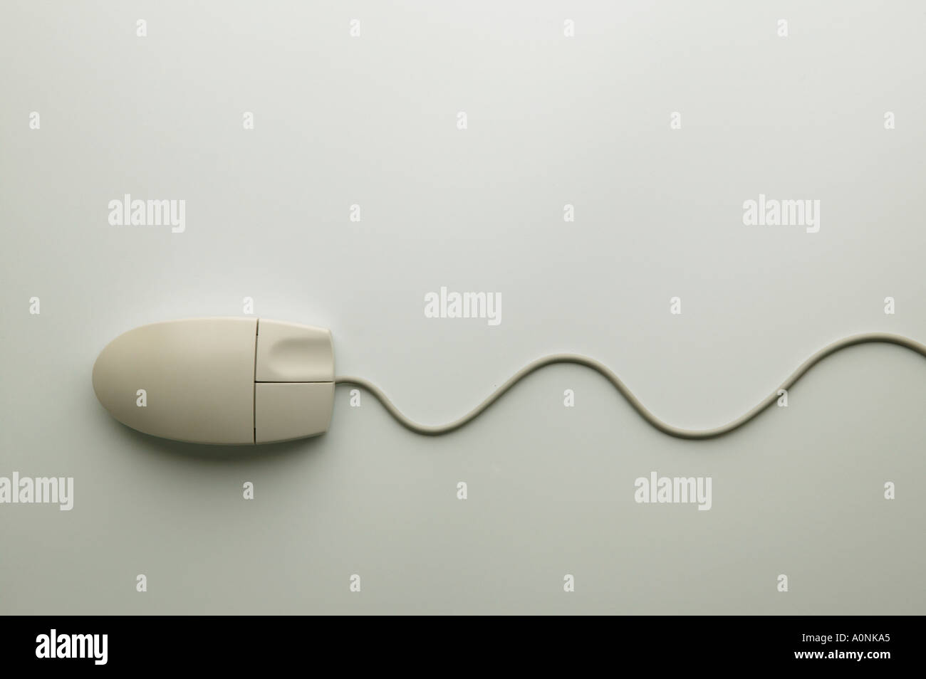 Cream coloured computer mouse on white background Stock Photo