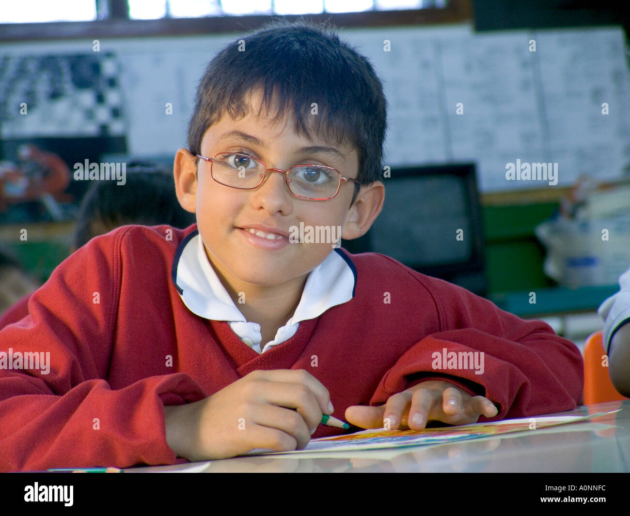 Portrait Of Junior Schoolboy Wearing Spectacles In Classroom Situation Portrait Of Junior Schoolboy Wearing Spectacles In Classroom Situation