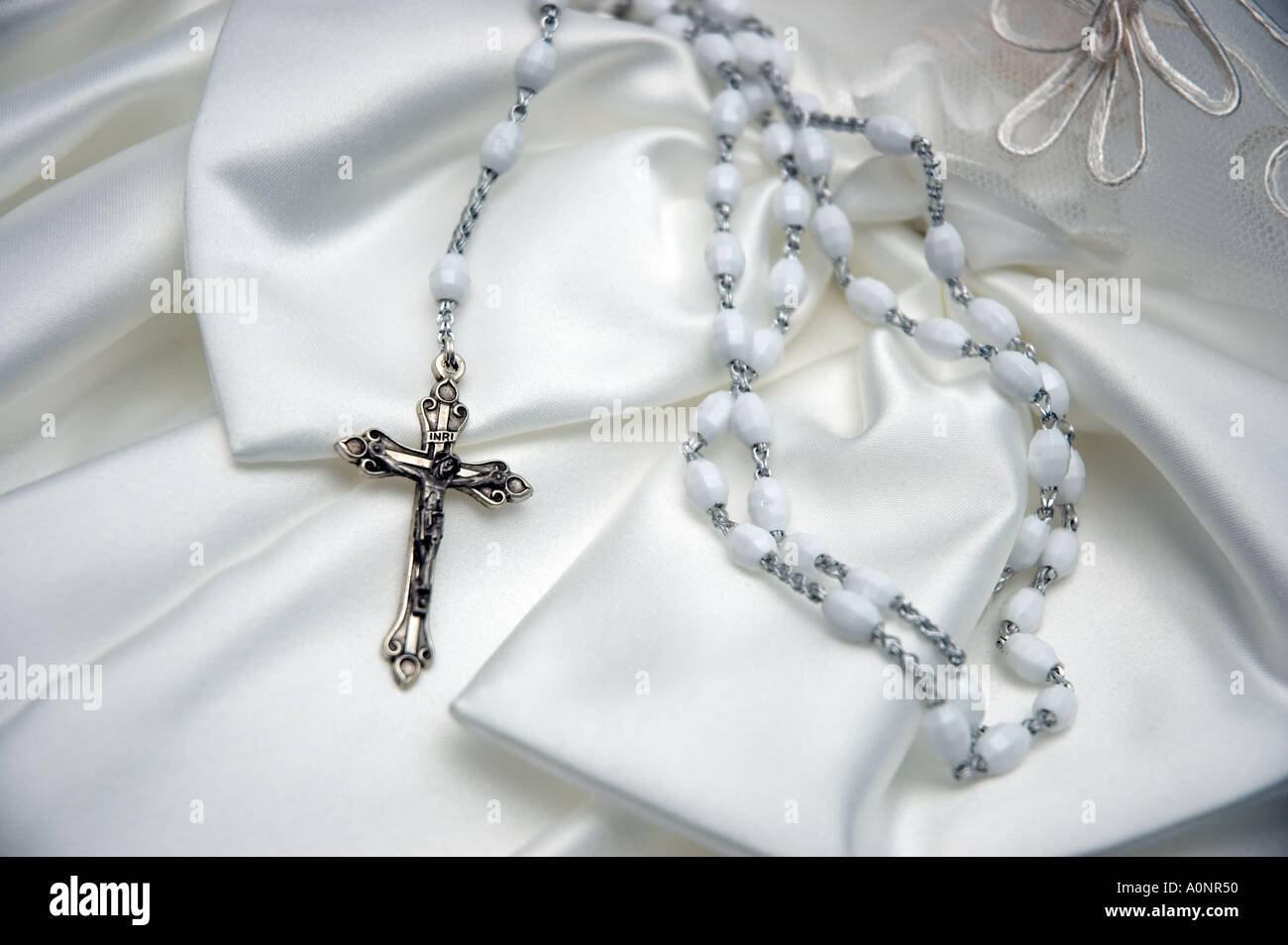 Crucifix and satin dress rosary beads Stock Photo