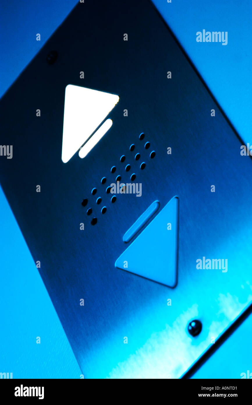 A blue colured elevator sign showing the lift going up on a chrome background illuminated arrow Stock Photo