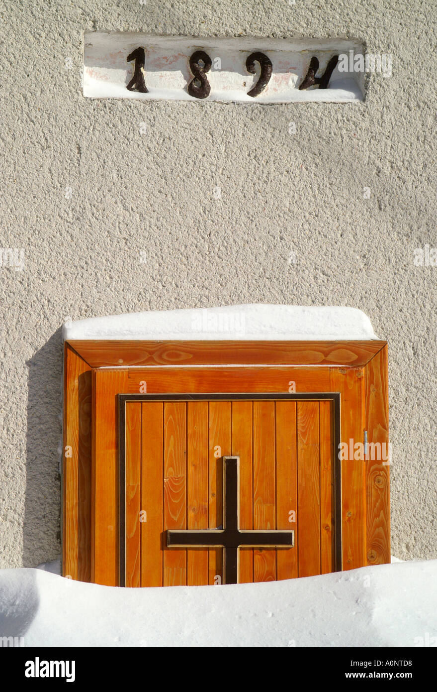 Church doors in a snowdrift in Donovaly ski resort village, Slovakia Stock Photo