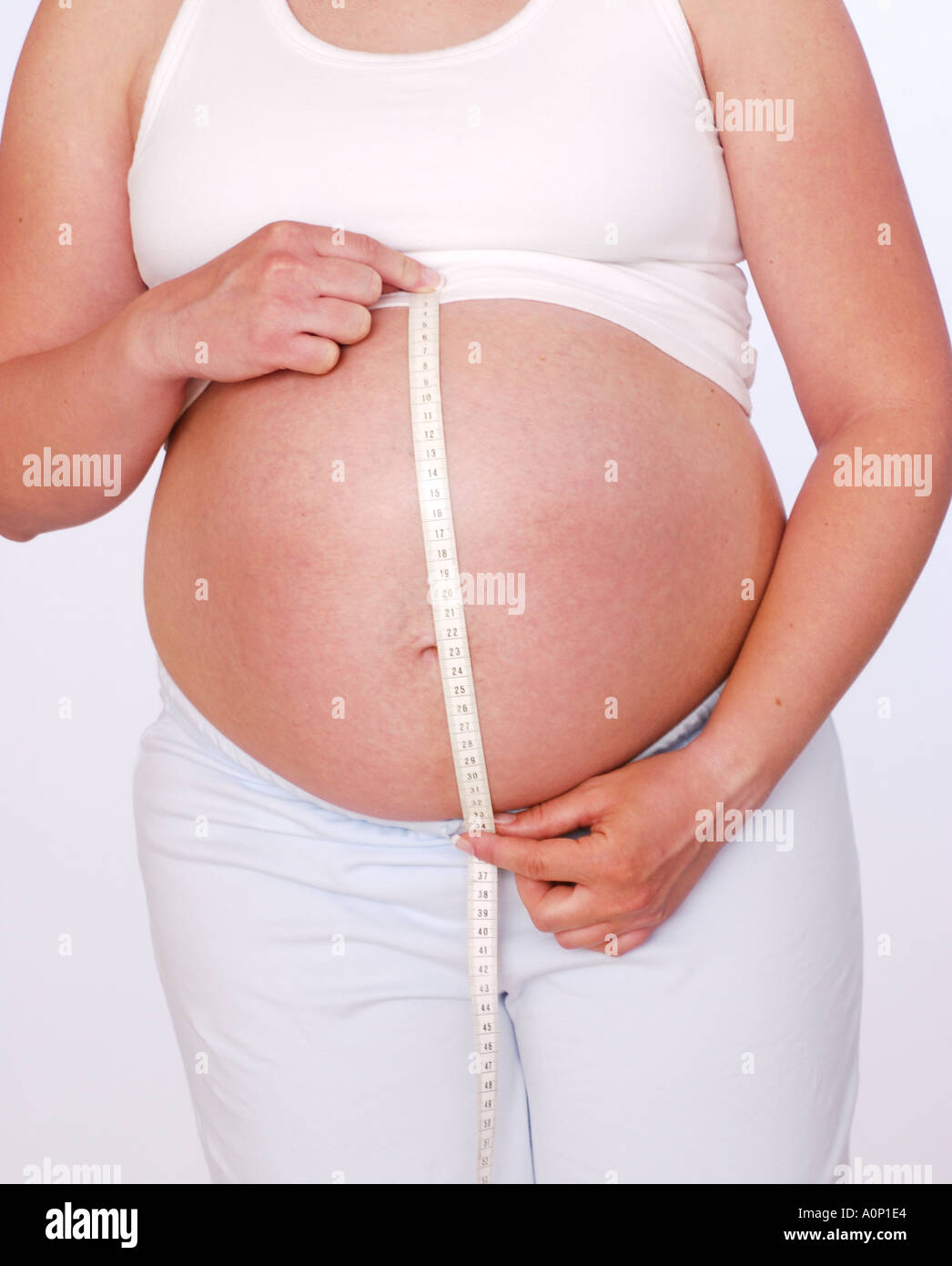 Pregnant woman measuring stomach with tape measure Stock Photo Alamy