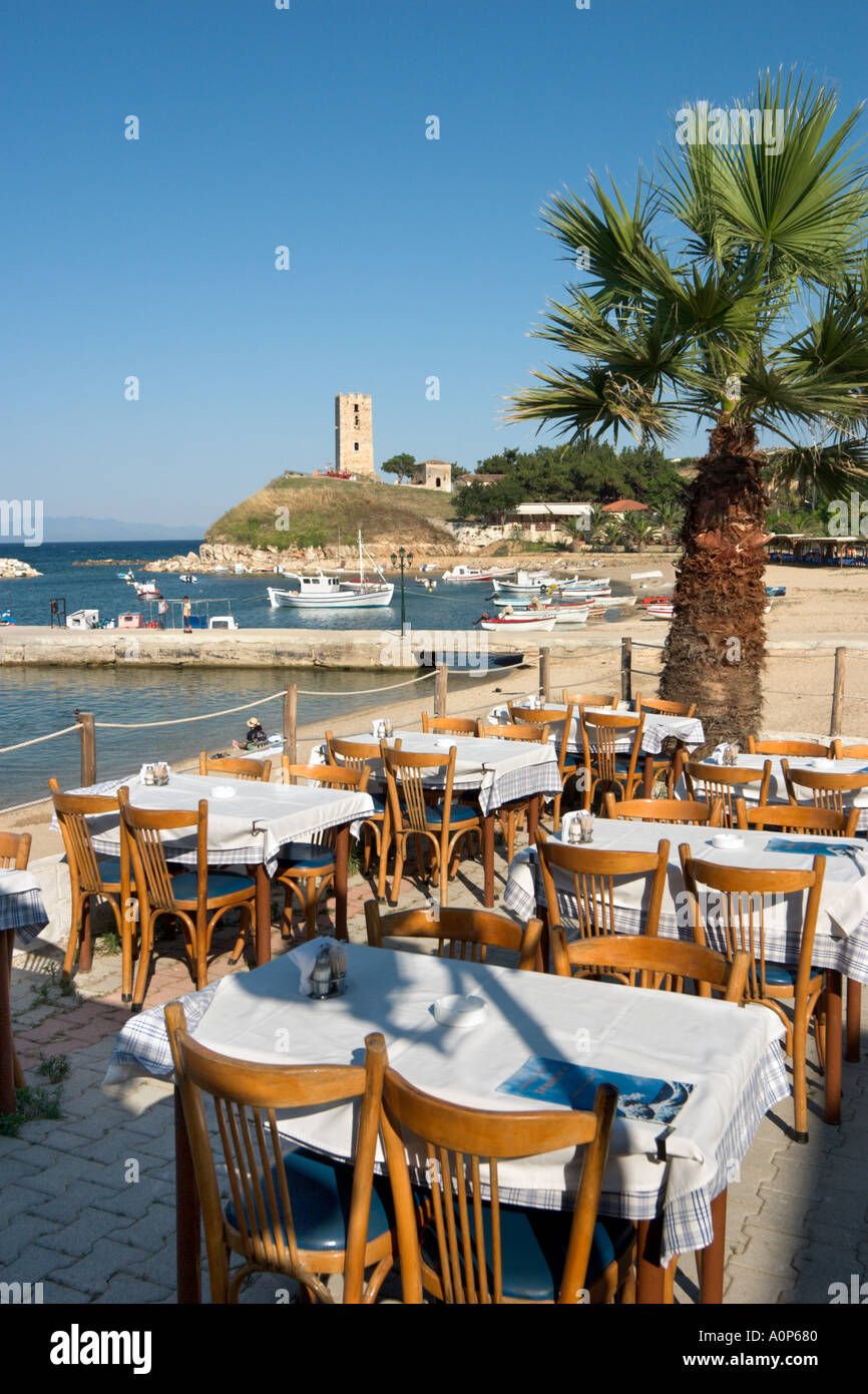 Seafront Taverna, Harbour and Byzantine Watchtower in the early evening, Nea Fokia, Kassandra Peninsula, Halkidiki, Greece Stock Photo