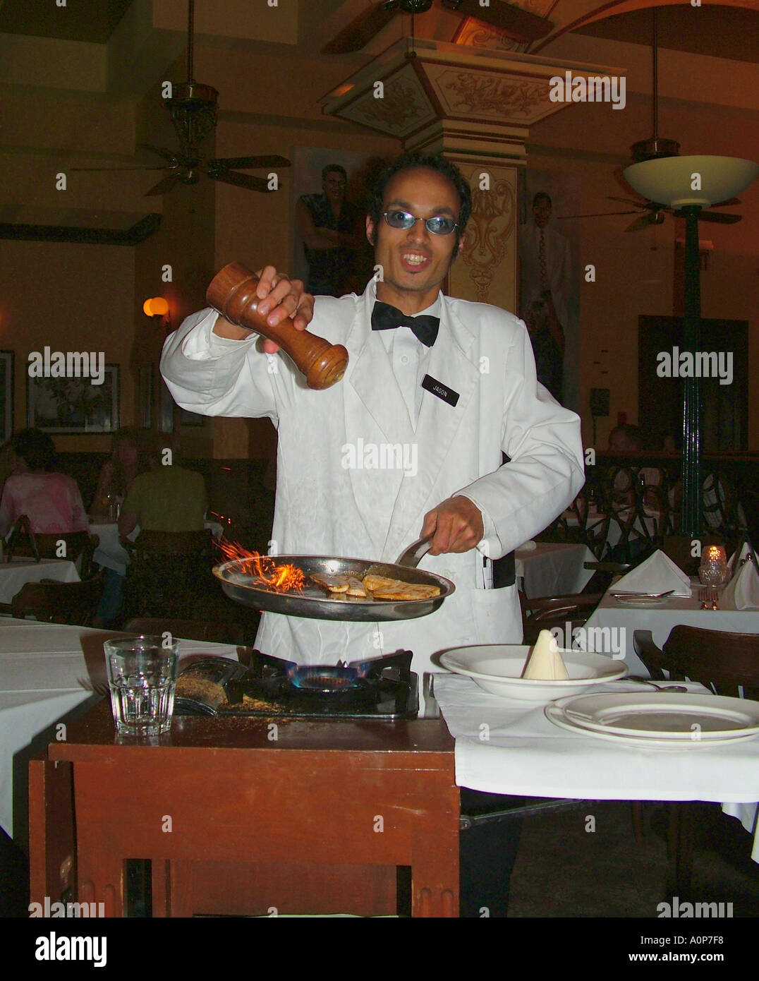 Waiter cooks a Banana flambe at Dickie Brennan s Palace cafe Canal