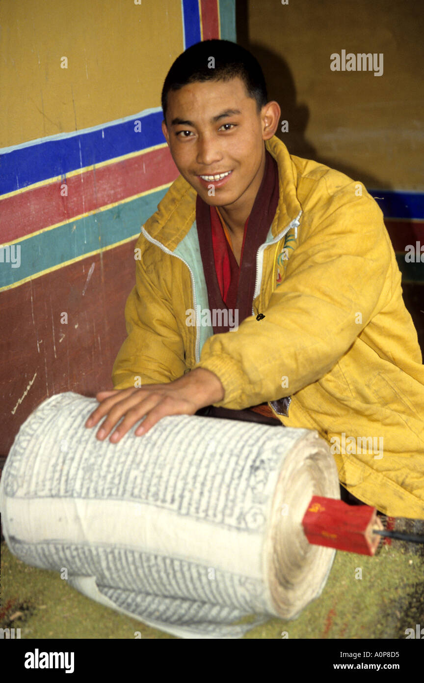 A  Tibetan monk working on holy papers and scrolls in a monastery in Tibet. Stock Photo