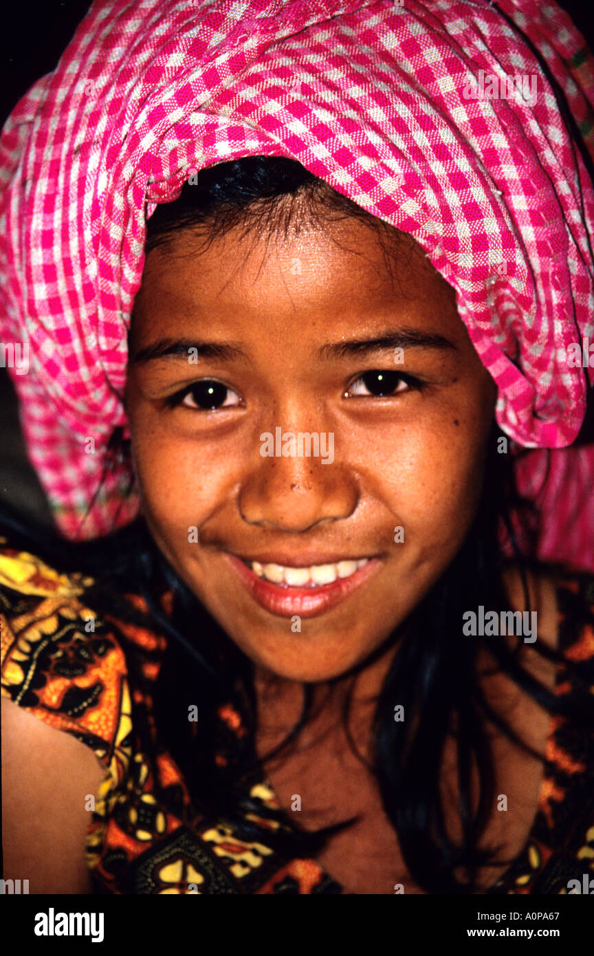smiling Cambodian girl wearing traditional krama or checked scarf at Angkor Wat,Siem Reap Stock Photo