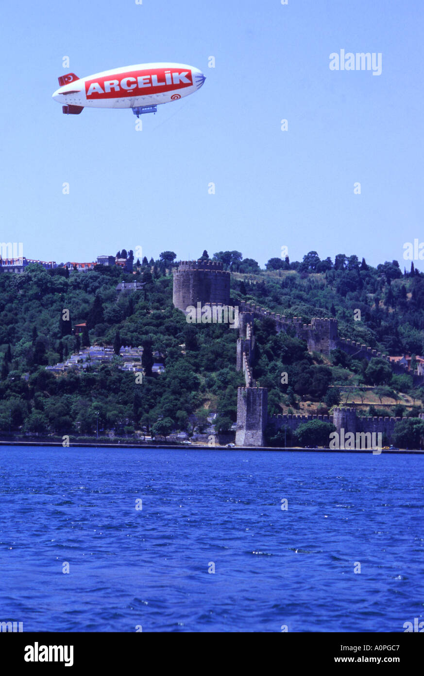 Arcelik Airship Cruises Over The Bosphorus Waterway with Rumel Hisari Fort In the Background Stock Photo
