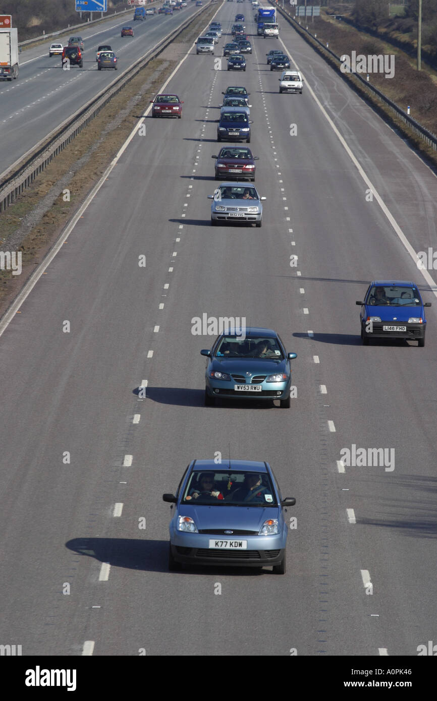 Motorway car vehicle traffic driving in the centre lane  road transport Stock Photo
