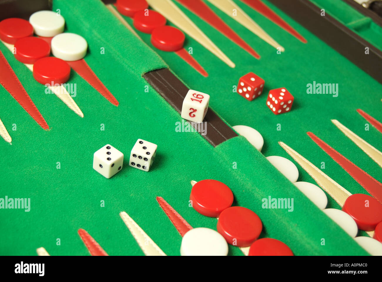 Close up shot of Backgammon game in designer case with red and white checkers, two red dice. Stock Photo