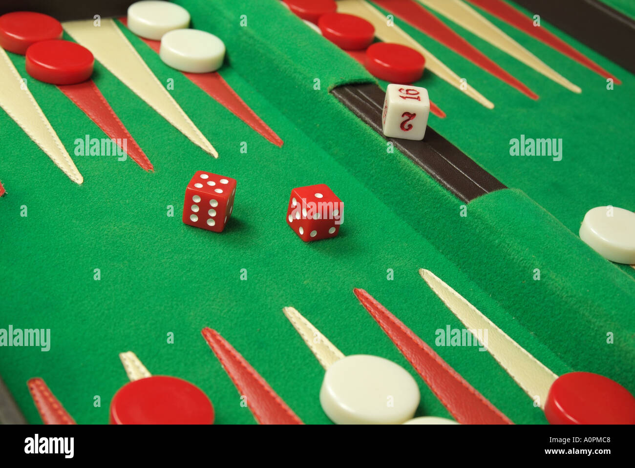 Close up shot of Backgammon game in designer case with red and white checkers, two red dice. Stock Photo