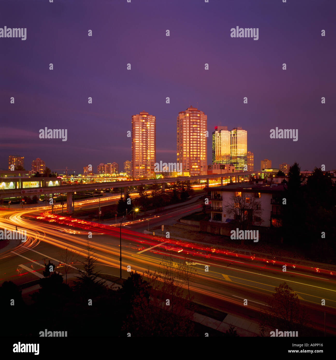 Burnaby, BC, British Columbia, Canada - High Rise Buildings at Metrotown, Street Traffic Light Streaks at Night Stock Photo