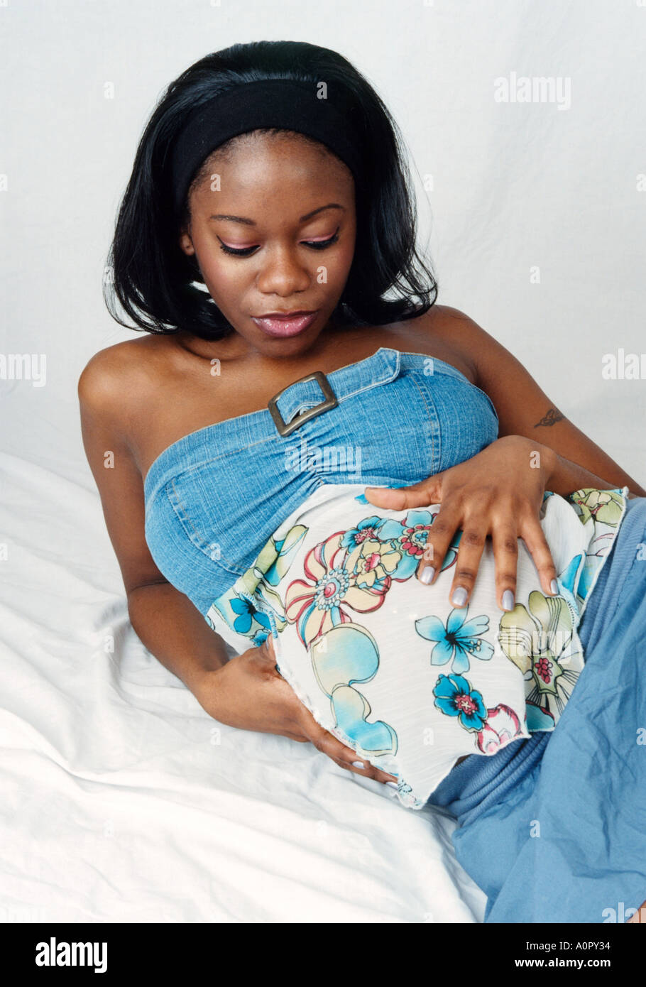 Portrait of a Pregnant Black Girl in a Blue Dress Stock Photo