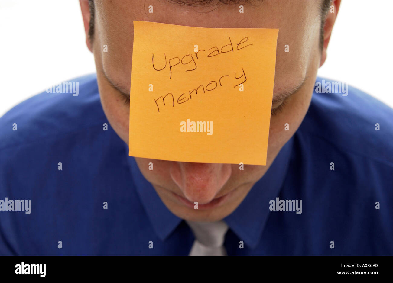 Businessman with post it note on forehead Stock Photo Alamy