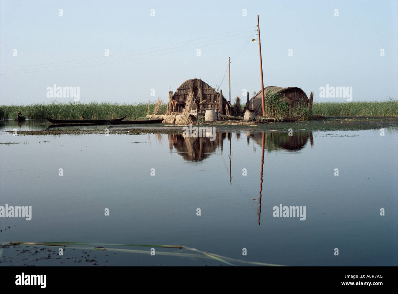 Reed houses and boat Marshes Iraq Middle East Stock Photo