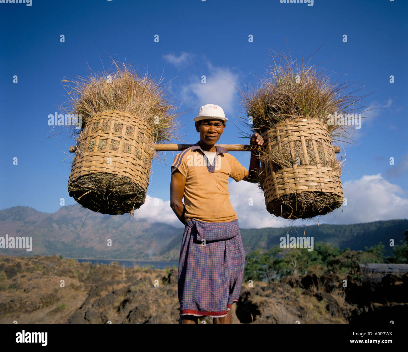 Farmer carrying baskets Bali Indonesia Southeast Asia Asia Stock Photo