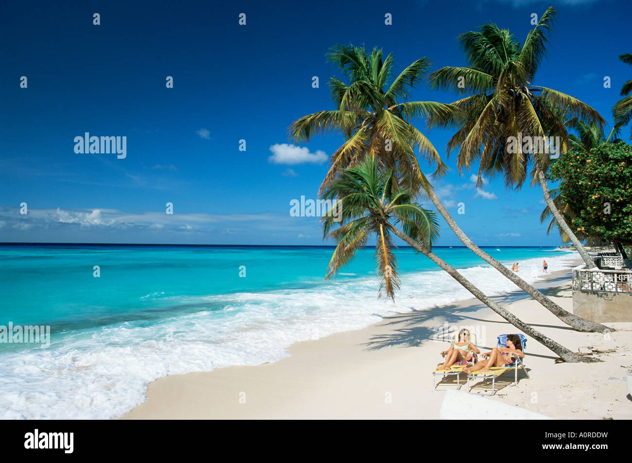 Sunbathers on Worthing Beach on the south coast Christ Church Barbados West Indies Caribbean Central America Stock Photo