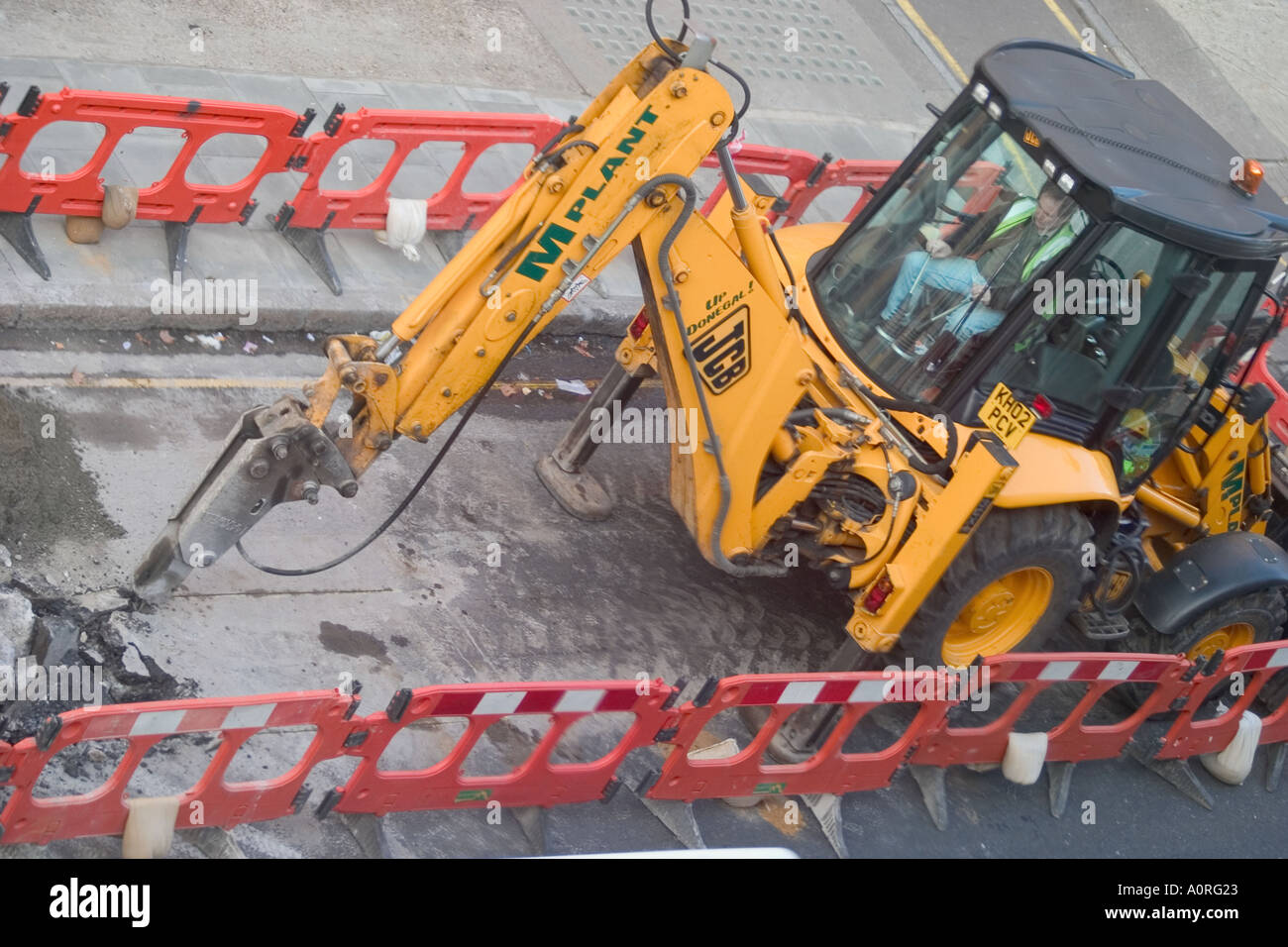 JCB digging up road. Bloomsbury, London, England Stock Photo Alamy