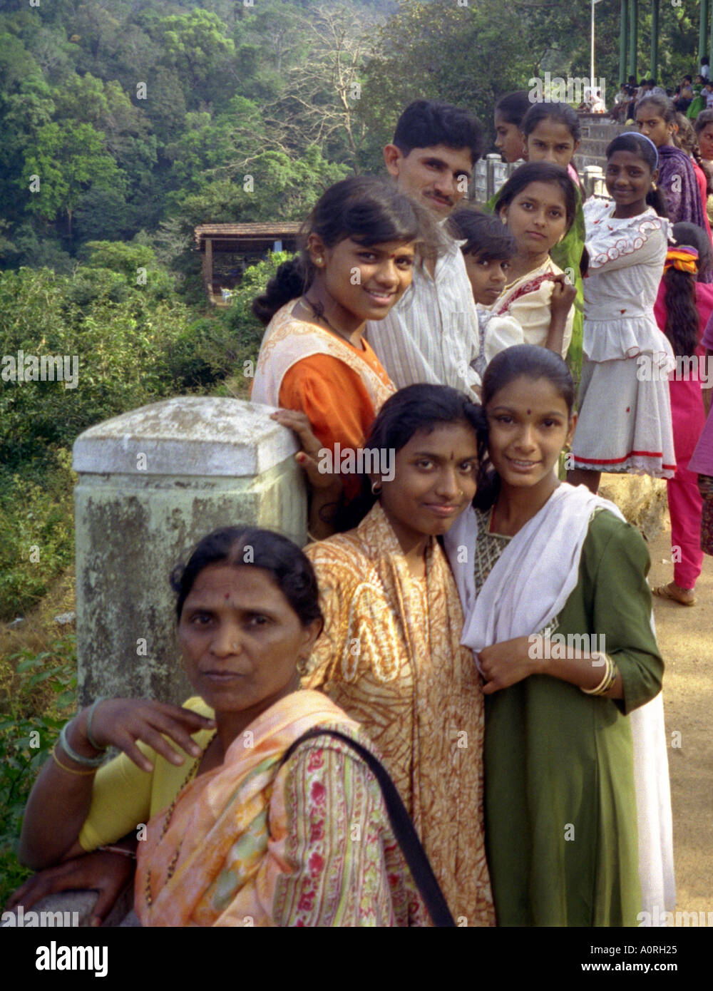 Group of women girls & man in colourful traditional clothing looking interested Jog Falls Karnataka India South Asia Stock Photo