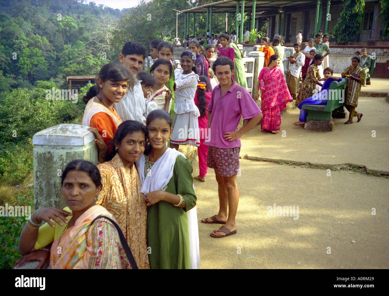 Group of women girls & man in colourful traditional clothing looking interested Jog Falls Karnataka India South Asia Stock Photo