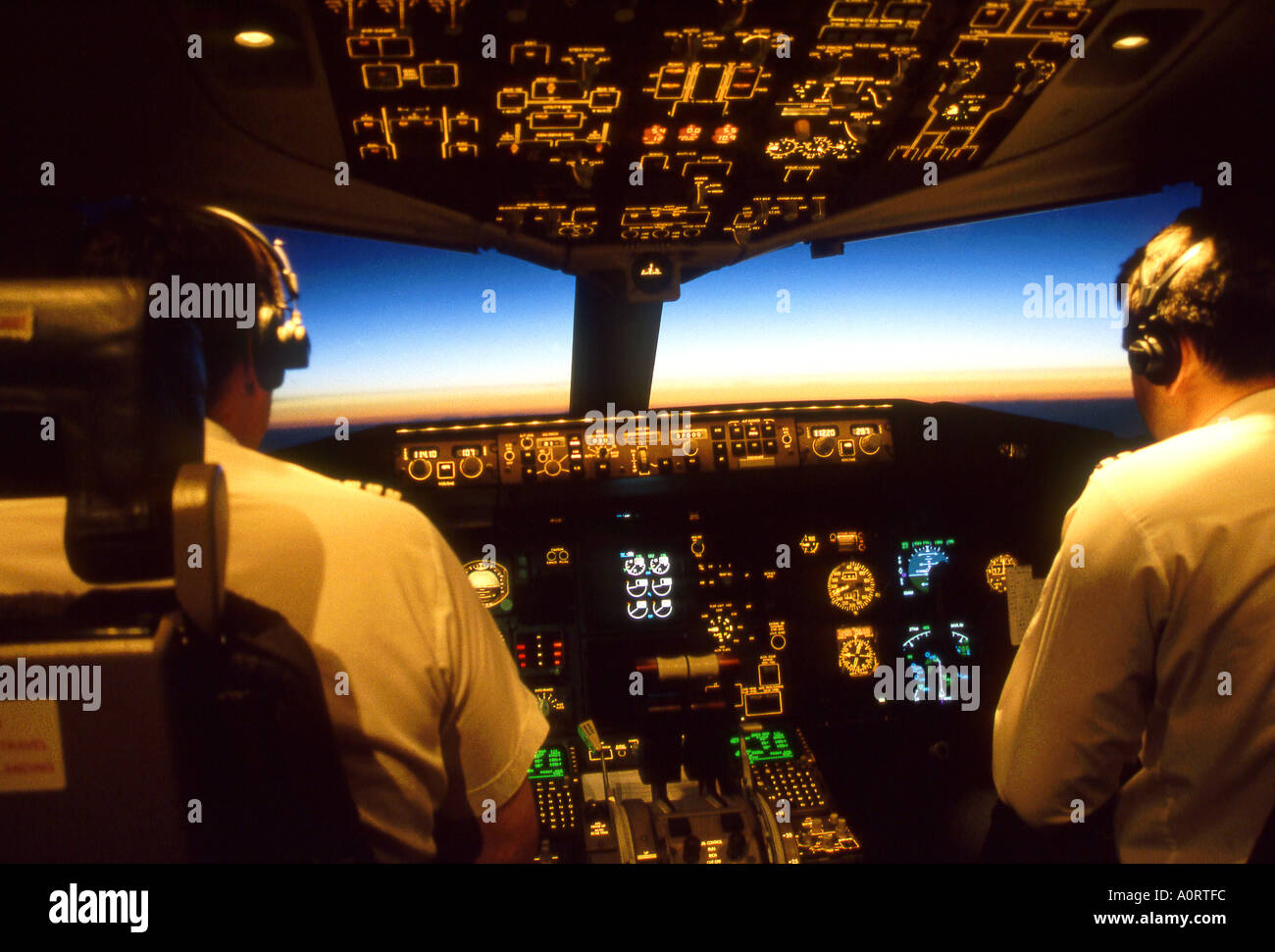 Pilots in Boeing 757 Cockpit Early Morning Stock Photo