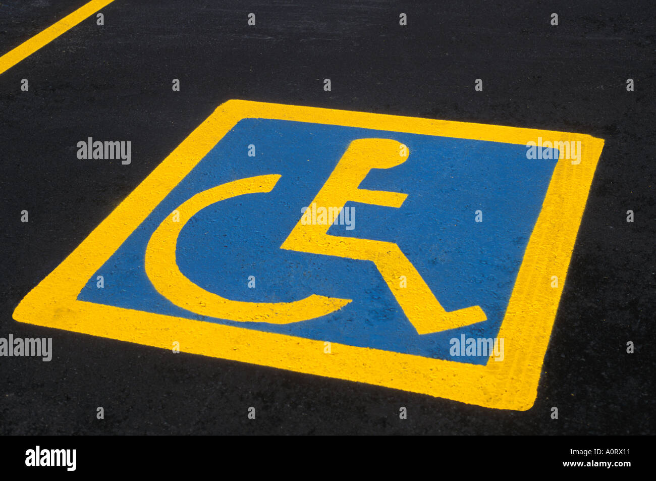 Wheelchair sign painted on parking stall indicating parking for
