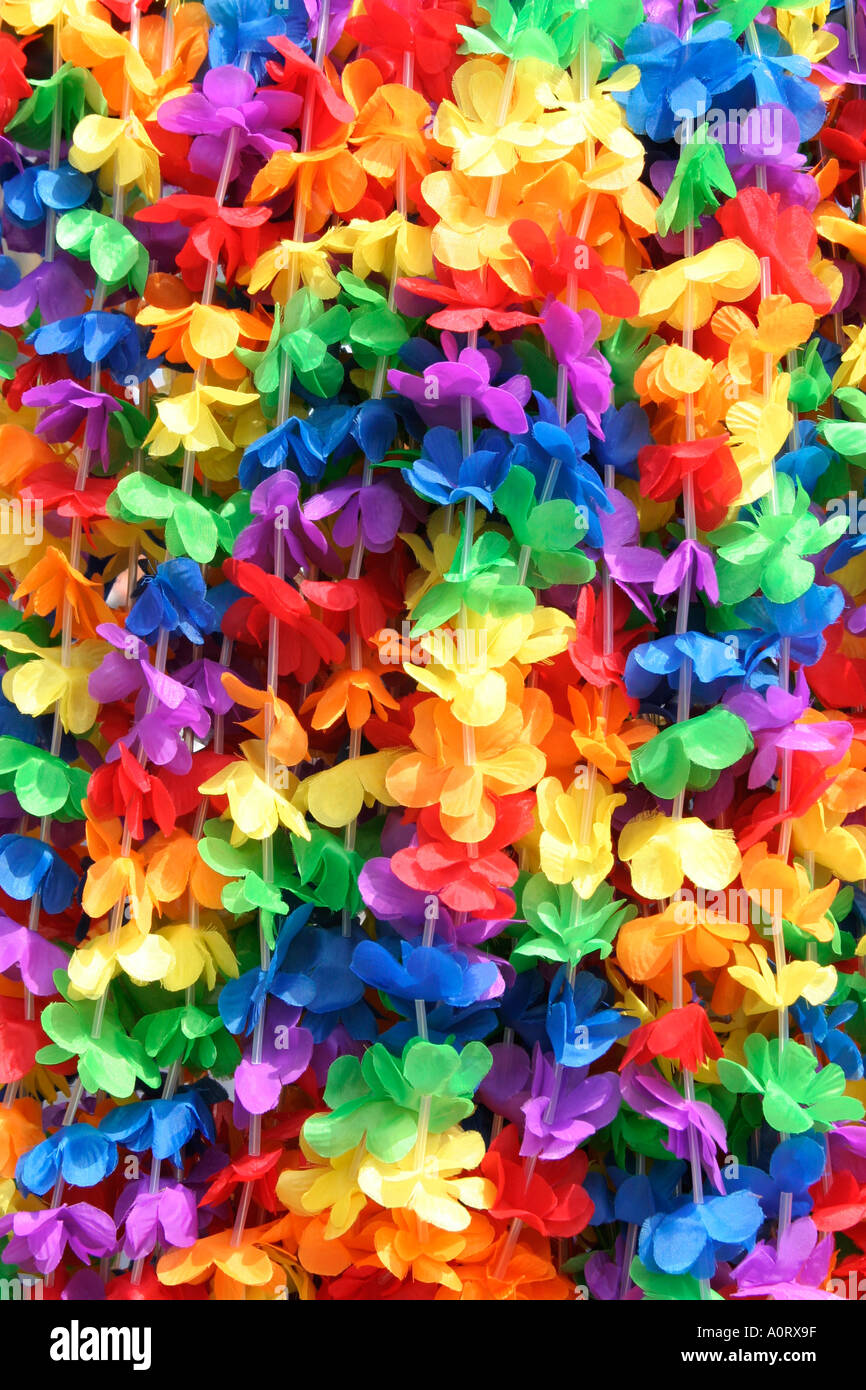 Hanging multi colored artificial flower garlands used as costume elements in a carnival parade party or festival event Stock Photo