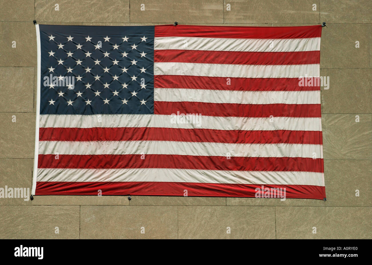 Large American flag attached to a wall on the side of a building Stock ...